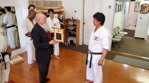 Ray Reddy presenting a commemorative plaque to Sensei Takahashi